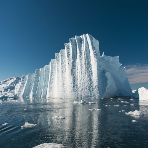A vertical shot of a massive iceberg in Disko Bay, Greenland
